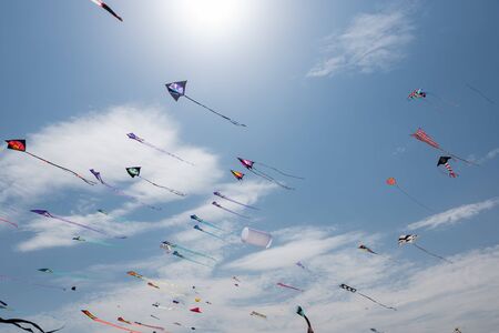 Kites with blue sky and white cloudsの写真素材