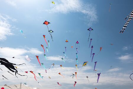 Kites with blue sky and white cloudsの写真素材