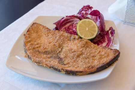 Sword cutlet on white plateの写真素材