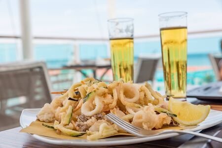Fried mixed fish with ice-cold beerの写真素材