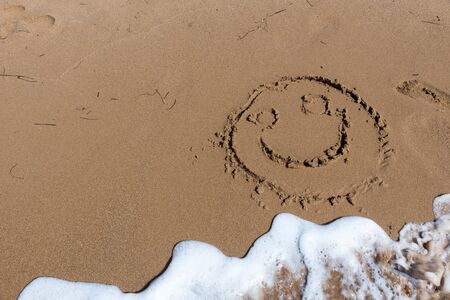 Smile draw on the shore of the seaの写真素材