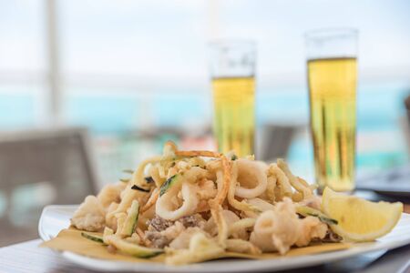 Fried mixed fish with ice-cold beerの写真素材