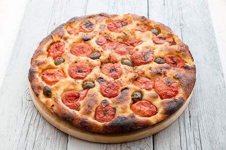 Focaccia typical of Bari Italy with tomatoes and oliveの写真素材
