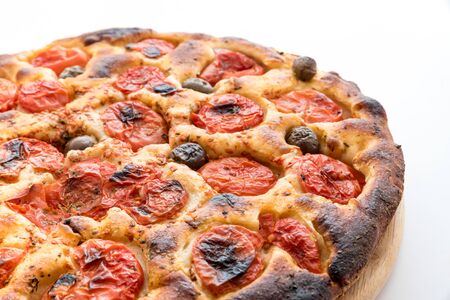 Focaccia typical of Bari Italy with tomatoes and oliveの写真素材