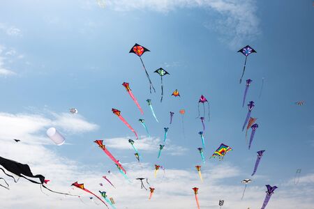 Kites with blue sky and white cloudsの写真素材