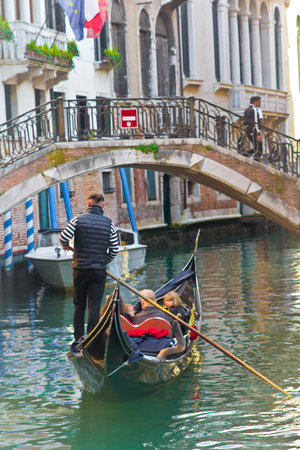 gondolier on gondola boat in venice in italyの写真素材