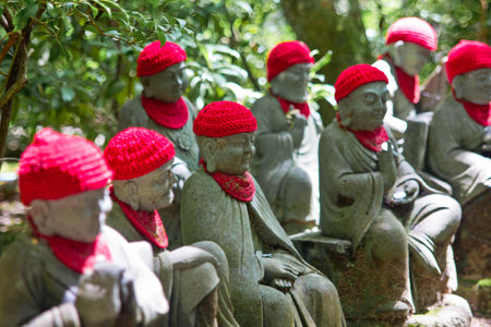Statues of Buddhist monks in the temple, closeup of photo