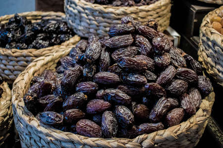 Black raisins in a rope basket of a marketの写真素材