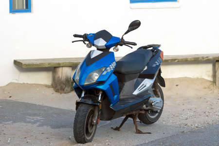 Black and blue scooter parked outdoors in Denmarkの写真素材