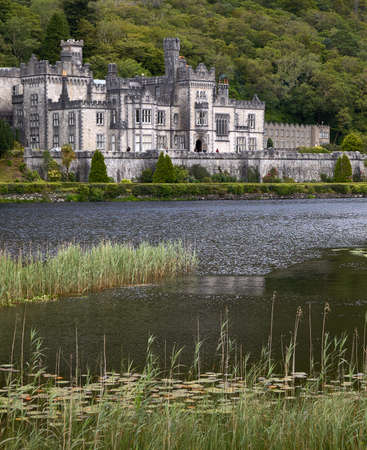 Kylemore abbey in Connemara with its beautiful lake in the foregroundのeditorial素材