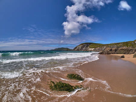 Wild waves crashing against a rock on Dingle peninsula, Ireland