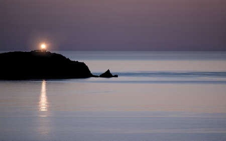 Lighthouse in Calvi, Corsica, on a calm summer eveningの写真素材