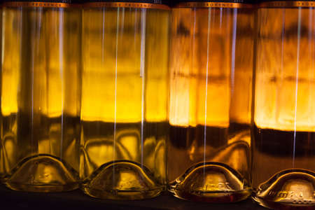 Row of lighted white wine bottlesの写真素材