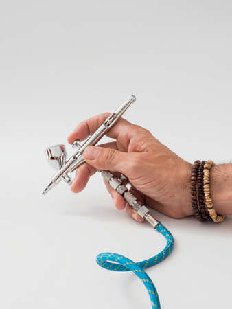 hand of a man holding an airbrushの写真素材