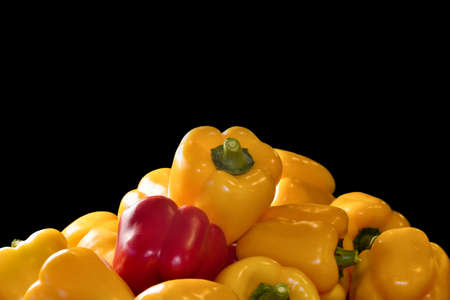 many Fresh Sweet yellow, red bell peppers. black background for half image