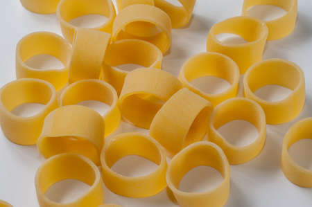 Italian dry raw pasta. squid rings, macaroni, bronze die on white background top view