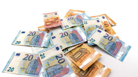 several Euro cash banknotes scattered on the white backgroundの写真素材