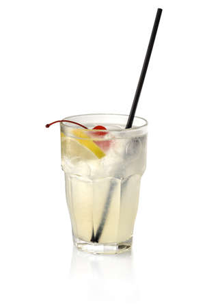 Gin fizz Cocktail with lemon slice, candied cherry, ice cubes and black straw in glass isolated on white backgroundの写真素材