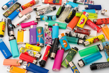 TURIN, ITALY - JUNE 5, 2021: Used lighters of different shapes and types with multi-colored graphic brandsのeditorial素材