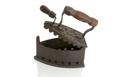 Antique open iron for ironing with hot coals in cast iron with wooden handle isolated on whiteの写真素材
