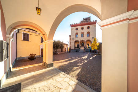 Barolo, Cuneo, Italy - November 05, 2021: Piazza Falletti with the Falletti Castle, seat of the WiMu Wine Museum, seen from the arch of the parish church of San Donatoのeditorial素材