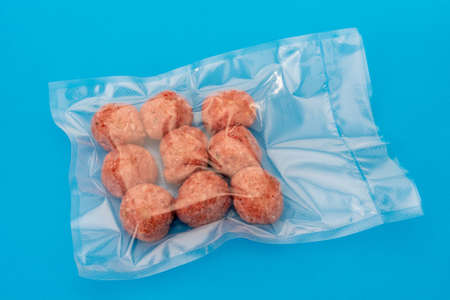 Meatballs in vacuum packed sealed for sous vide cooking on blue background, top viewの写真素材