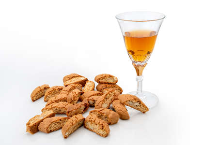 Cantuccini almond cookies with glass of Vin Santo sweet wine isolated on white. Typical Tuscan products, Italy. Copy spaceの写真素材