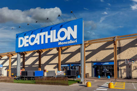 Moncalieri, Turin, Italy - December 6, 2021: Decathlon logo on sign at entrance store on blue sky with clouds, Decathlon is largest sporting goods retailer in the worldのeditorial素材