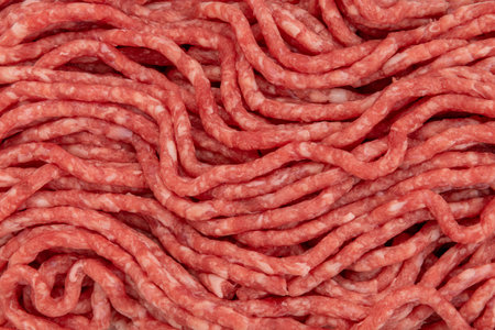 Beef mince meat texture background, raw minced meat in close-up in top viewの写真素材