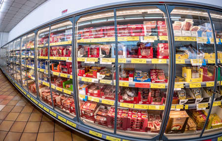 Fossano, Italy - February 26, 2022: Refrigerated showcases with packs of Salami, ham, cheese with affordable prices in INS italian discount store, INS is a brand of PAM group, fish eye visionのeditorial素材