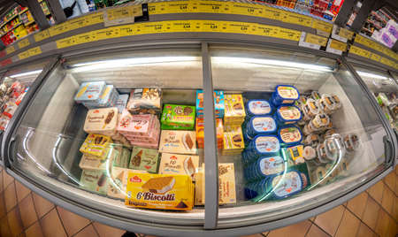 Fossano, Italy - March 12, 2022: Refrigerated counter with packs of ice creams for sale in INS supermarket discount store, PAM group. Fish eye vision in top viewのeditorial素材