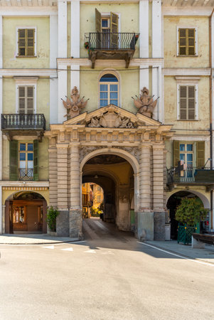 Saluzzo, Cuneo, Italy - April 15, 2022: historic building with the Porta Santa Maria, gateway to the old city, con columns of Renaissance style with tympanum with the Savoy coat of armsのeditorial素材