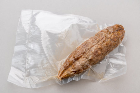 Italian salami in vacuum packed sealed for sous vide cooking isolated on Gray background in top view.の写真素材