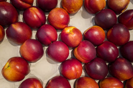 Nectarines in cassette for sale, top view of peaches Necatrines ripe