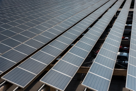 Rows of solar panels on parking. Photovoltaic solar cells energy farm for production of clean...
