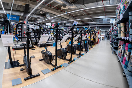 Wedge; Italy - November 22; 2022: large assortment of stationary bikes for indoor biking exercise displayed in fitness department in italian Decathlon store; fish eye viewのeditorial素材
