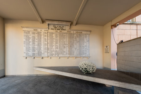 Boves, Cuneo, Italy - November 22, 2022: view of World War II memorial Stone (Memorial to the Fallen ) placed under arcade of Town hall building. Boves was a heroic partisan city with many fallenのeditorial素材