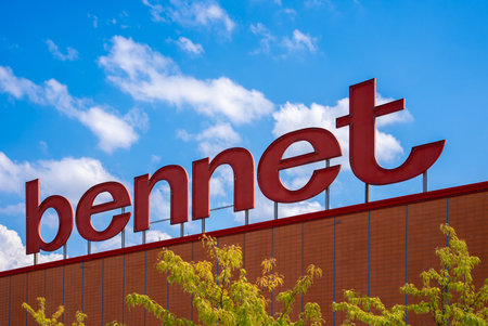 Santa Vittoria di Alba, Cuneo, Italy - august 16, 2022: Bennet logo outside the shopping on blue sky center in Santa Vittoria Di Alba. It is a hypermarket chain operating in North Italyのeditorial素材