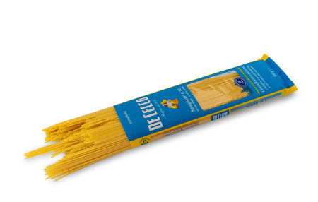 Italy - december 26, 2022: De Cecco pasta spaghetti packaging, spaghetti coming out of envelope isolated on white, clipping path. De Cecco is famous Italian pasta factory from the Abruzzo regionのeditorial素材