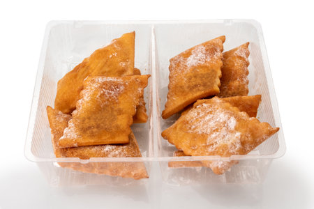 Lies or frappe or chiacchiere or angel wings. Traditional italian carnival dessert in transparent...