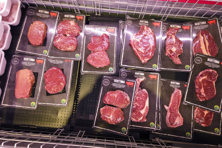 Italy - January 11, 2023: vacuum packs of beef steaks and ribs in refrigerated counter for sale in Italian supermarket,のeditorial素材