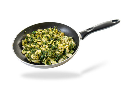 Orecchiette pasta with pan-fried turnip tops, typical Italian recipe from Puglia region in pan isolated on white with clipping pathの写真素材