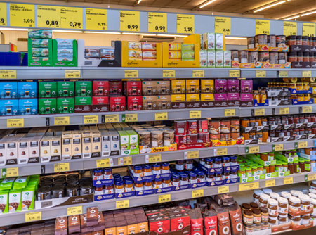 Turin, Italy - April 27, 2023: packs of coffee, barley, coffee machine capsules, teabags and herbal teas and jams on shelves for sale in Italian supemarketのeditorial素材