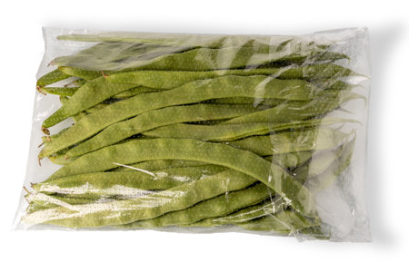 Runner beans packaged in clear plastic bag for sale isolated on white with clipping path included