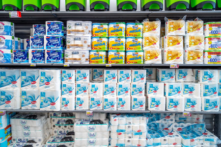 Italy - June 22, 2023: Packs of toilet paper and hand paper towel roll on shelves for sale in Italian supermarketのeditorial素材