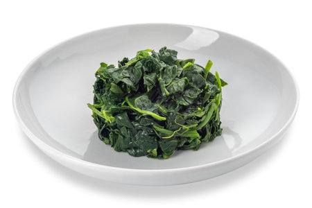 Spinach cooked in white dish isolated on white with clipping path includedの写真素材