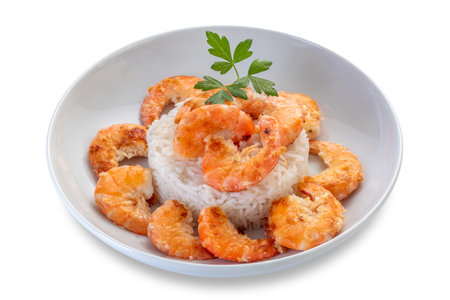 Fried shrimps with rice in white dish with parsley leaves, isolated on white with clipping path includedの写真素材