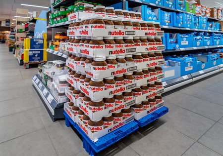 Italy - August 05, 2023: Ferrero Nutella in stacked glass jars for sale on pallets displayed in...