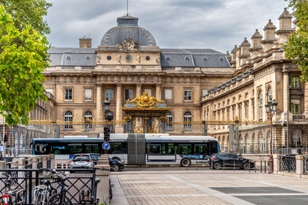 Paris, France - 10 August 2023: Hybrid ecological bus of the Ile de France company Mobilites in front of the Palais de Justice (palace of justice), in boulevard du Palais.のeditorial素材