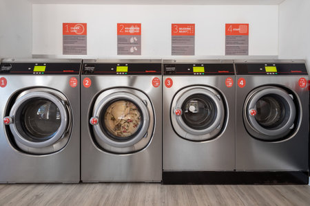Fossano, Italy - September 26, 2023: Washing machines in Speed Queen chain self-service laundry, number one commercial laundry in the worldのeditorial素材